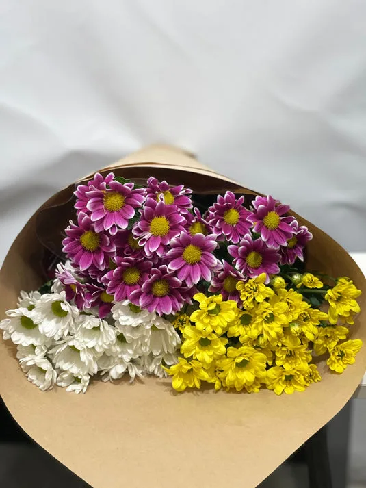 Purple, white and yellow spray-chrysanthemum bouquet in kraft-paper wrap